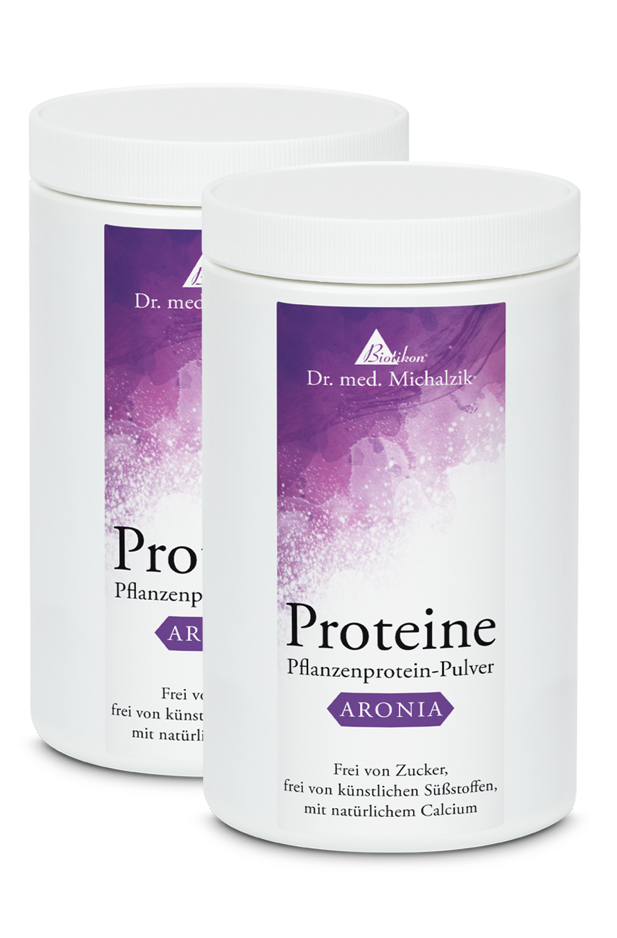 Poudre de protéine végétale Aronia – 500 g Deux contenants de poudre de protéine végétale blanche avec une étiquette violette, 500 g.